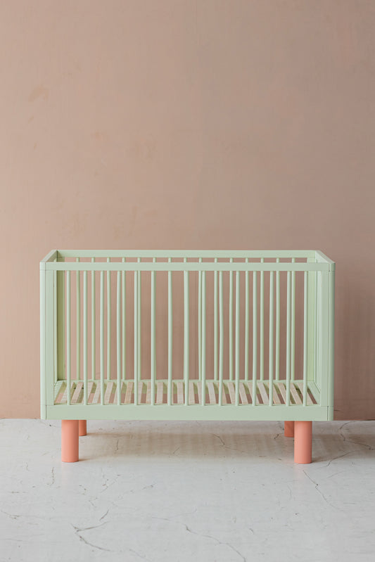 Nox cot in pistachio and pink