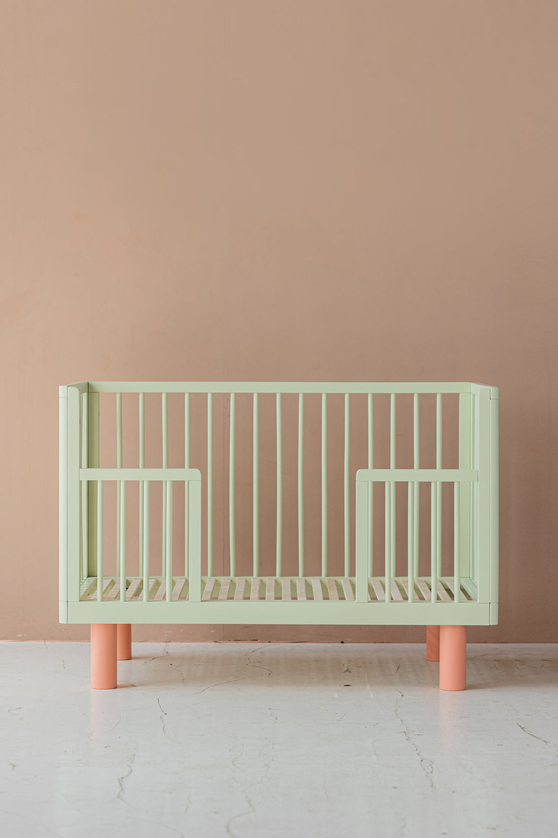 Nox cot in pistachio and pink + conversion rail in pistachio